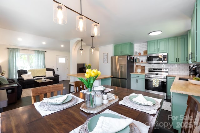 dining room with recessed lighting and dark wood-style flooring