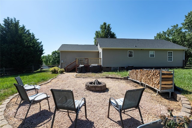 back of house featuring a fire pit, a wooden deck, crawl space, and fence