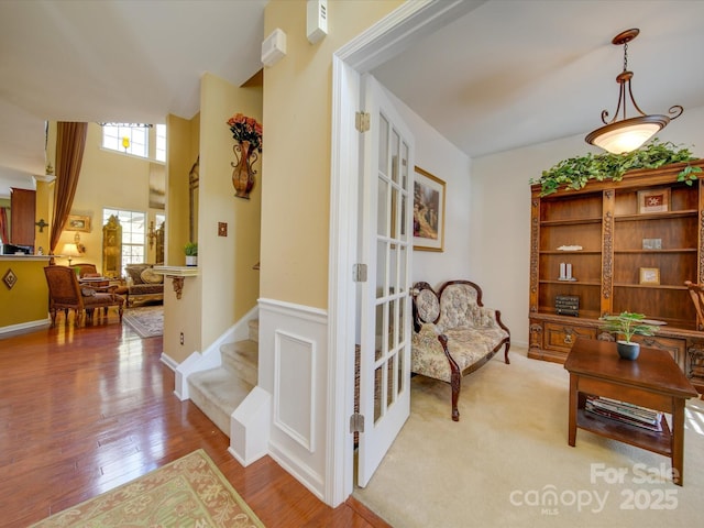 5076 Timber Falls Dr, Indian Land, SC 29707 - interior space featuring stairway, wainscoting, and light wood finished floors