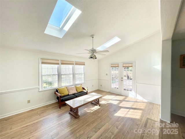 944 Evian Ln, Matthews, NC 28015 - living area with a skylight, french doors, lofted ceiling, healthy amount of natural light, and light wood-style floors