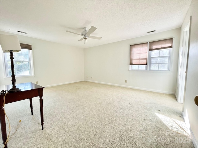 944 Evian Ln, Matthews, NC 28015 - empty room with healthy amount of natural light, a ceiling fan, light colored carpet, baseboards, and a textured ceiling