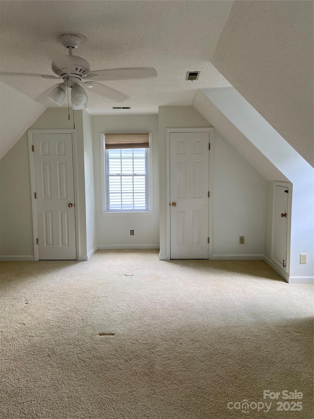 944 Evian Ln, Matthews, NC 28015 - additional living space featuring carpet flooring, vaulted ceiling, a ceiling fan, baseboards, and a textured ceiling