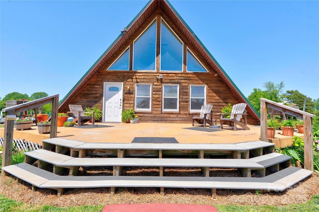 back of property with a wooden deck