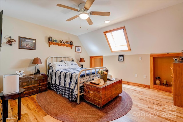 bedroom with light wood finished floors, recessed lighting, a ceiling fan, baseboards, and lofted ceiling with skylight