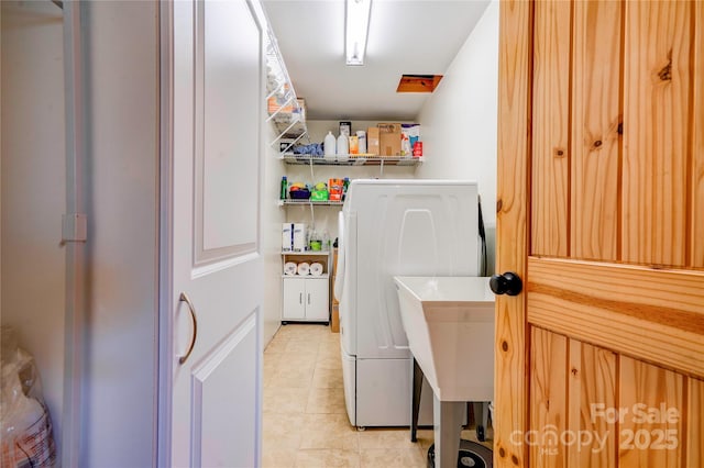 clothes washing area featuring washer / clothes dryer, laundry area, and light tile patterned floors