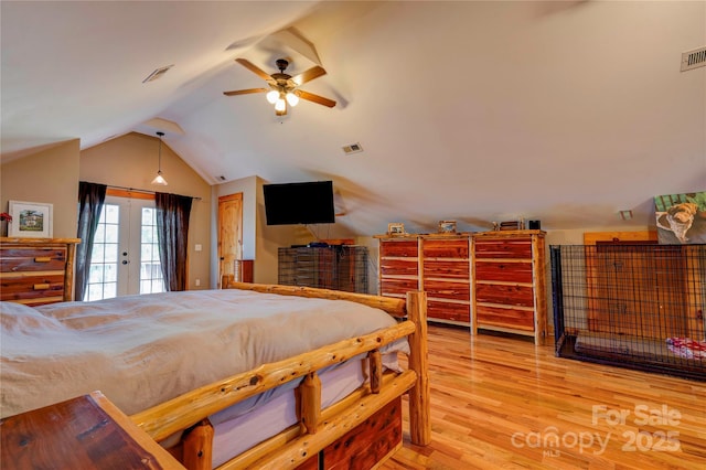 bedroom with visible vents, lofted ceiling, light wood finished floors, and access to exterior