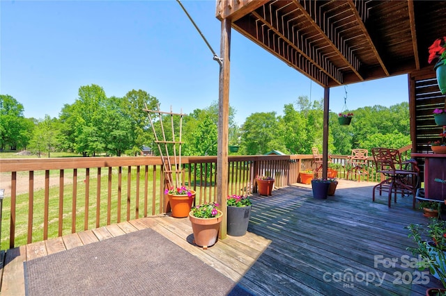 wooden terrace with a lawn