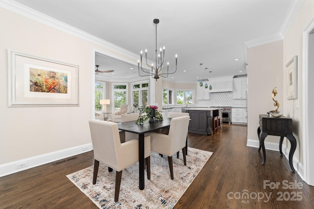 dining room with crown molding, dark wood-style flooring, baseboards, recessed lighting, and a notable chandelier