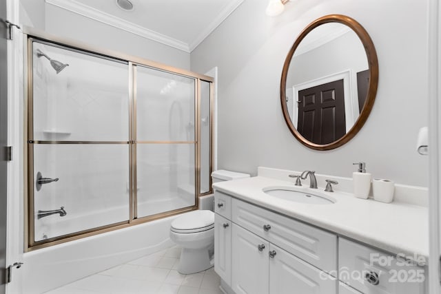 bathroom with vanity, toilet, tile patterned floors, enclosed tub / shower combo, and ornamental molding