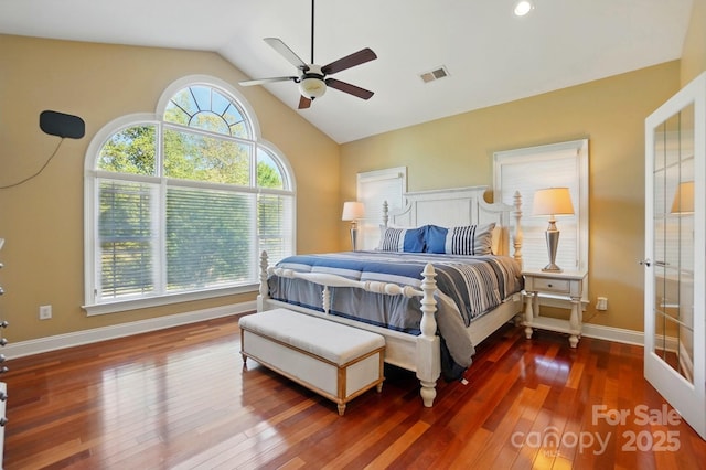 bedroom with ceiling fan, visible vents, baseboards, lofted ceiling, and hardwood / wood-style floors