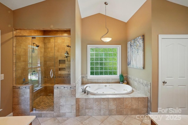 bathroom featuring tile patterned floors, a jetted tub, lofted ceiling, and a stall shower