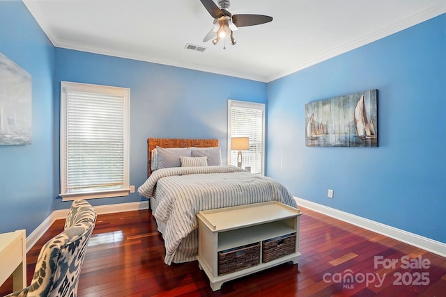 bedroom with baseboards, ornamental molding, wood-type flooring, and visible vents