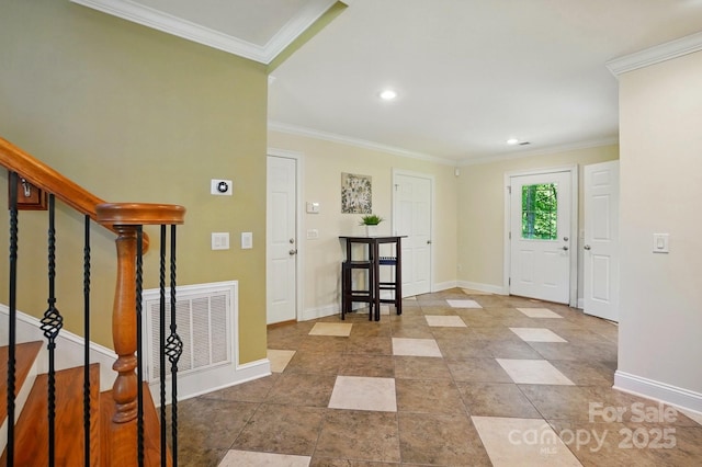 foyer with visible vents, crown molding, stairs, baseboards, and recessed lighting