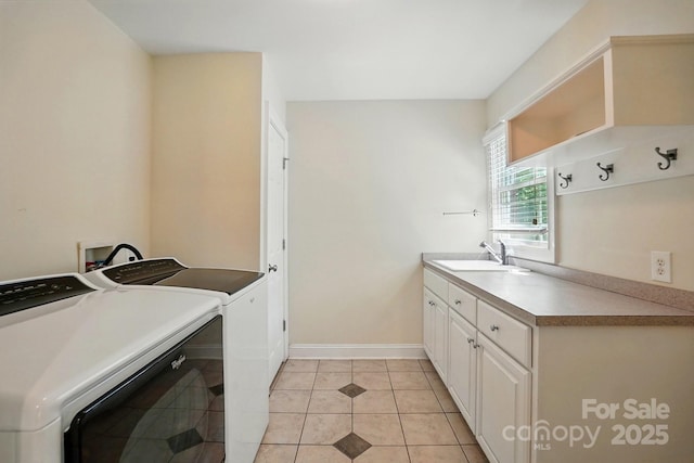 laundry room with independent washer and dryer, light tile patterned flooring, cabinet space, a sink, and baseboards