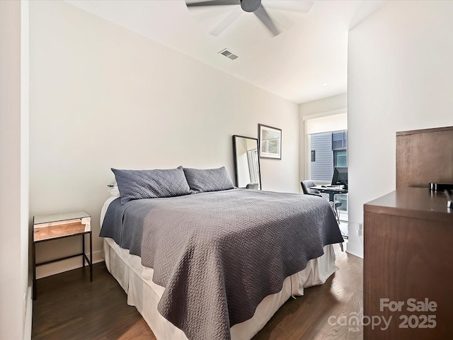 bedroom featuring a ceiling fan, wood finished floors, and visible vents
