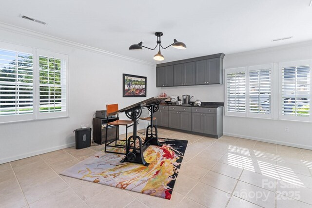 bar featuring plenty of natural light, ornamental molding, light tile patterned flooring, and visible vents