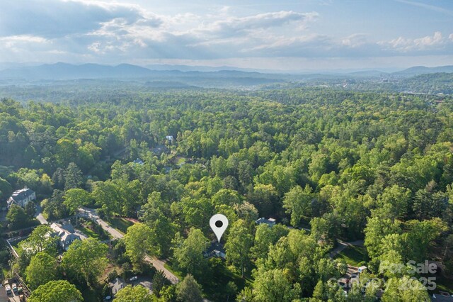 birds eye view of property with a mountain view and a forest view