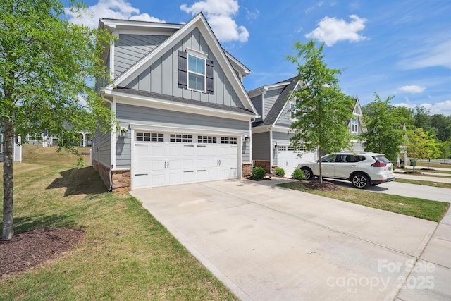 craftsman-style house with board and batten siding, driveway, a front lawn, and a garage