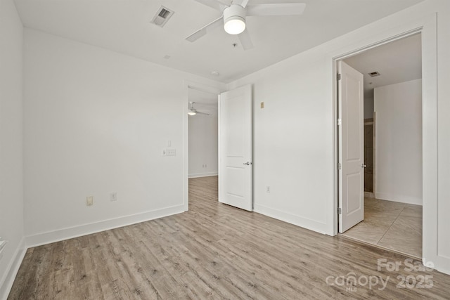 1101 W 1st St Unit 408, Charlotte, NC 28202 - unfurnished bedroom with wood finished floors, baseboards, and a ceiling fan