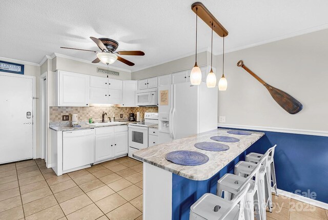 9660 Shore Dr Unit 208, Myrtle Beach, SC 29572 - kitchen with ceiling fan, a sink, white appliances, a peninsula, and visible vents