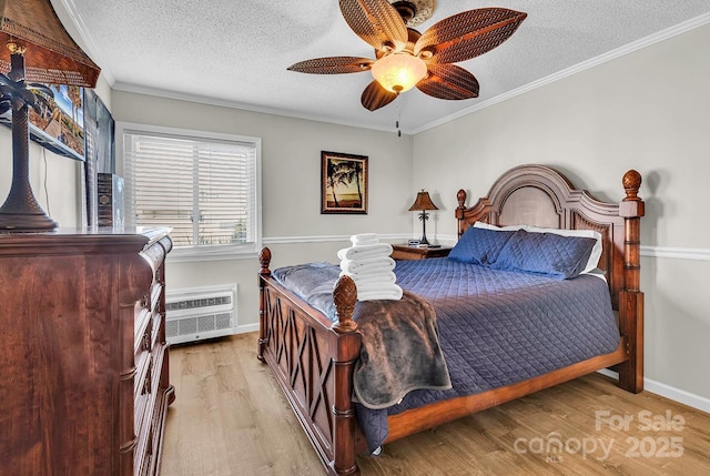9660 Shore Dr Unit 208, Myrtle Beach, SC 29572 - bedroom with crown molding, baseboards, a textured ceiling, and wood finished floors