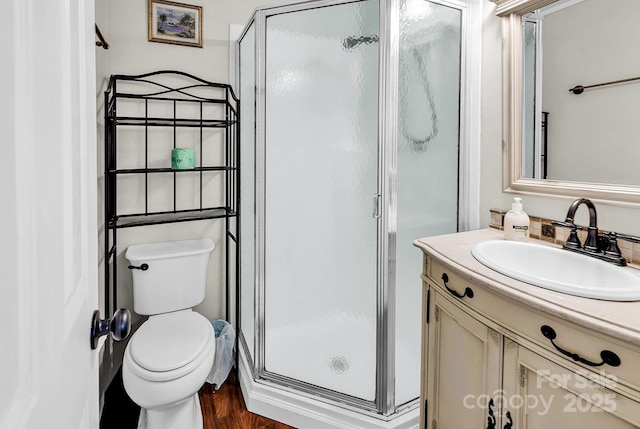9660 Shore Dr Unit 208, Myrtle Beach, SC 29572 - bathroom with vanity, a shower stall, toilet, and wood finished floors