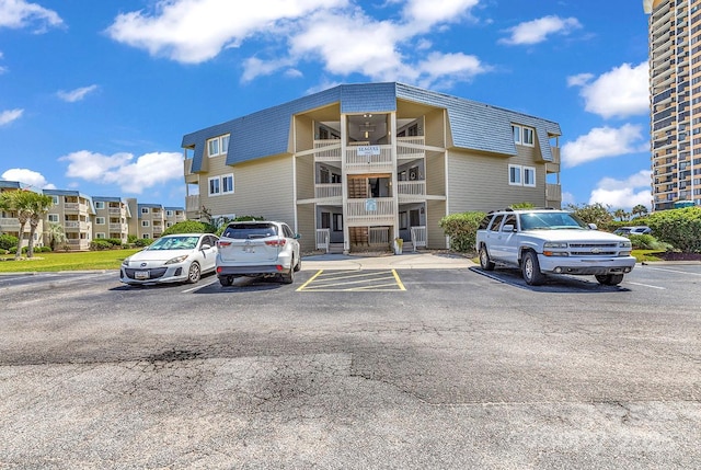 9660 Shore Dr Unit 208, Myrtle Beach, SC 29572 - view of building exterior featuring uncovered parking
