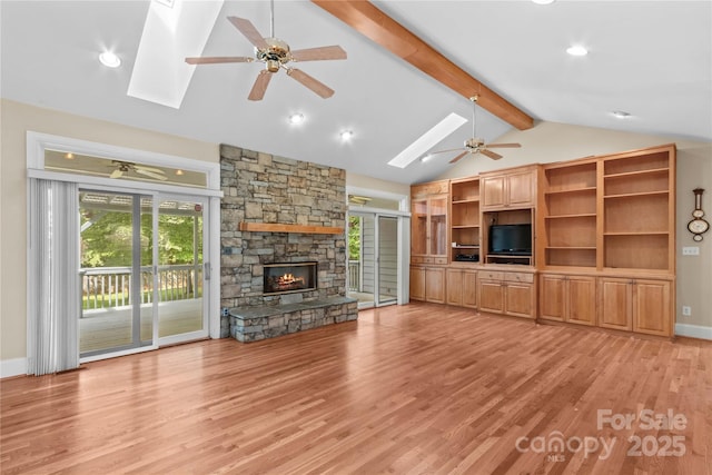 1760 Jacobs Way, Sherrills Ford, NC 28673 - unfurnished living room featuring a skylight, ceiling fan, light wood-style flooring, a stone fireplace, and recessed lighting