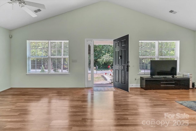 living room with wood finished floors, ceiling fan, and high vaulted ceiling