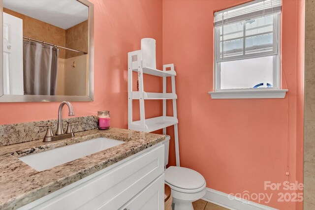 full bathroom with toilet, vanity, curtained shower, and tile patterned flooring