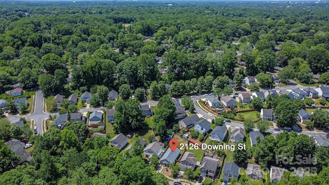 aerial overview of property's location featuring a heavily wooded area and nearby suburban area