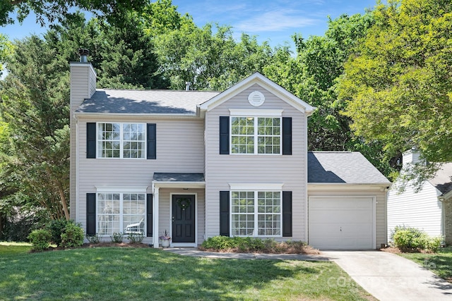 view of front of property featuring a chimney, roof with shingles, a front yard, concrete driveway, and an attached garage
