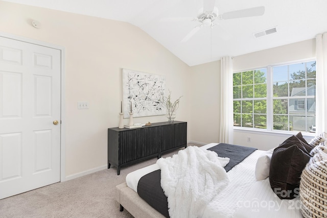 carpeted bedroom featuring baseboards, visible vents, ceiling fan, and vaulted ceiling