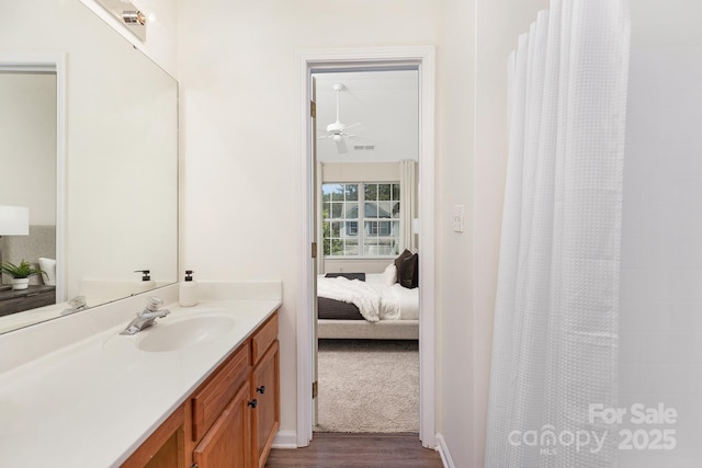 bathroom with vanity, wood finished floors, curtained shower, ensuite bathroom, and a ceiling fan
