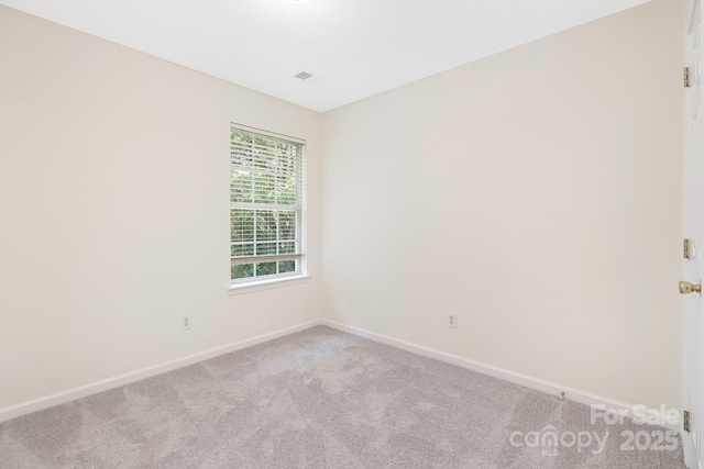 empty room with baseboards and light colored carpet