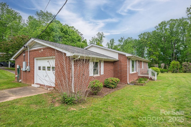 115 Patterson Rd, Kings Mountain, NC 28086 - view of side of property featuring driveway, a garage, brick siding, and a yard