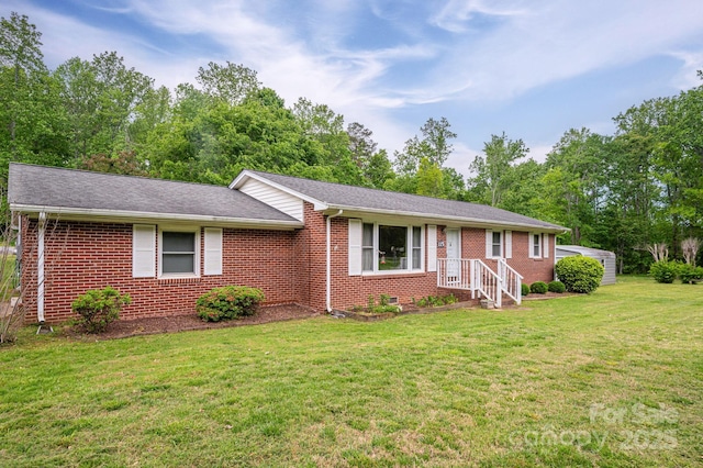 115 Patterson Rd, Kings Mountain, NC 28086 - ranch-style home with brick siding, a front lawn, a shingled roof, and view of wooded area