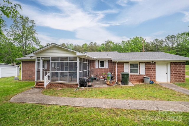 115 Patterson Rd, Kings Mountain, NC 28086 - view of front of home with a sunroom, brick siding, a front yard, and an outdoor structure