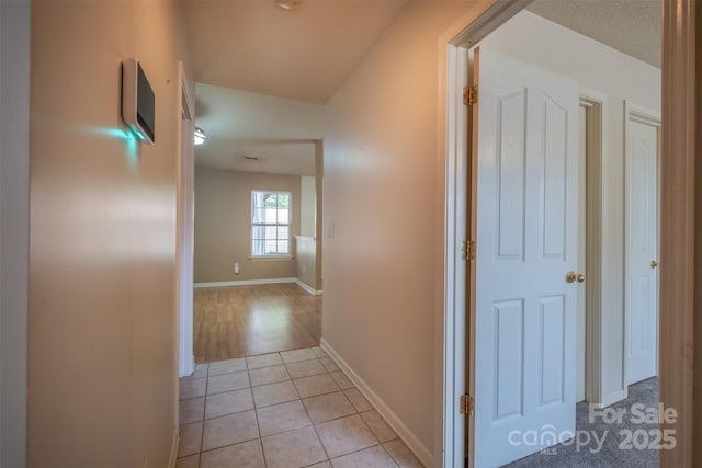 6808 Squirrels Foot Ct, Charlotte, NC 28217 - hall with baseboards and light tile patterned flooring