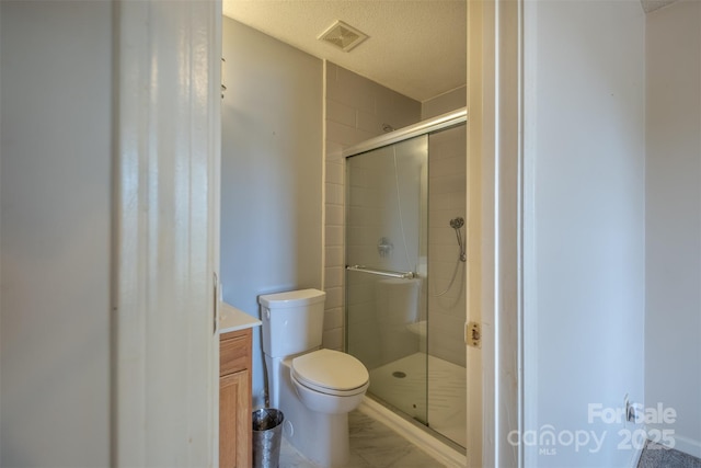 6808 Squirrels Foot Ct, Charlotte, NC 28217 - full bathroom with toilet, marble finish floor, a textured ceiling, visible vents, and a shower stall