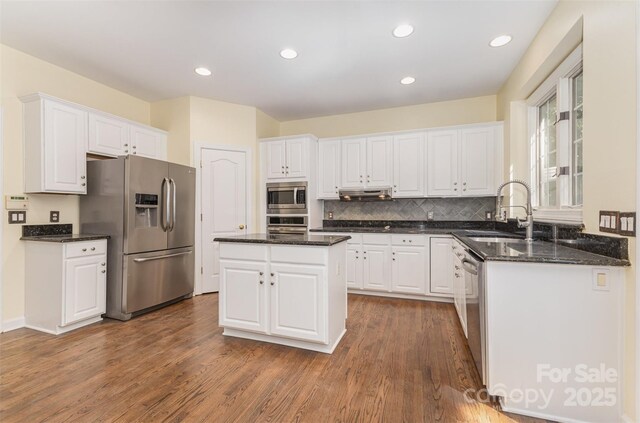 3710 Cheleys Ridge Ln, Charlotte, NC 28270 - kitchen with stainless steel appliances, a sink, under cabinet range hood, white cabinetry, and recessed lighting