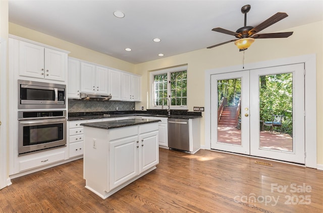 3710 Cheleys Ridge Ln, Charlotte, NC 28270 - kitchen with appliances with stainless steel finishes, french doors, wood finished floors, white cabinetry, and a center island