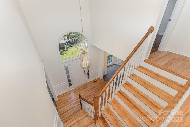 3710 Cheleys Ridge Ln, Charlotte, NC 28270 - stairway featuring a towering ceiling, wood finished floors, baseboards, and a chandelier