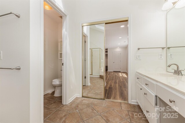 3710 Cheleys Ridge Ln, Charlotte, NC 28270 - bathroom with vanity, toilet, recessed lighting, tile patterned floors, and a shower with door