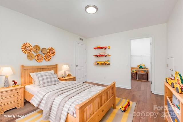 3710 Cheleys Ridge Ln, Charlotte, NC 28270 - bedroom with wood finished floors, a spacious closet, and baseboards