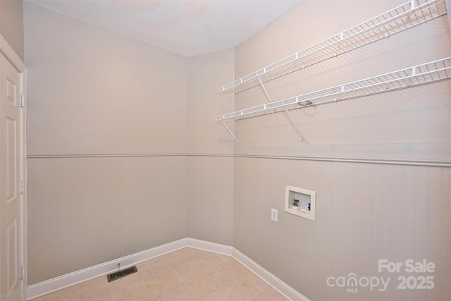 laundry area with visible vents, laundry area, washer hookup, and baseboards