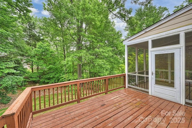 wooden deck featuring a sunroom