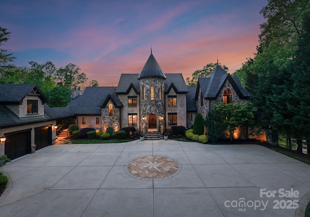 172 Tennessee Cir, Mooresville, NC 28117 - french country style house with stone siding, curved driveway, and a garage
