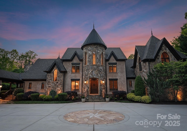 172 Tennessee Cir, Mooresville, NC 28117 - french country inspired facade featuring stone siding, stucco siding, and curved driveway