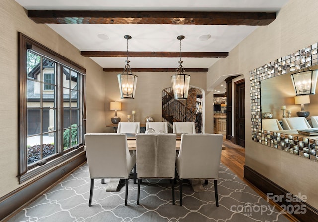 172 Tennessee Cir, Mooresville, NC 28117 - dining room with a chandelier, dark wood-style flooring, beamed ceiling, arched walkways, and baseboards